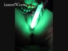 Horny honey uses a luminous sextoy to masturbate.